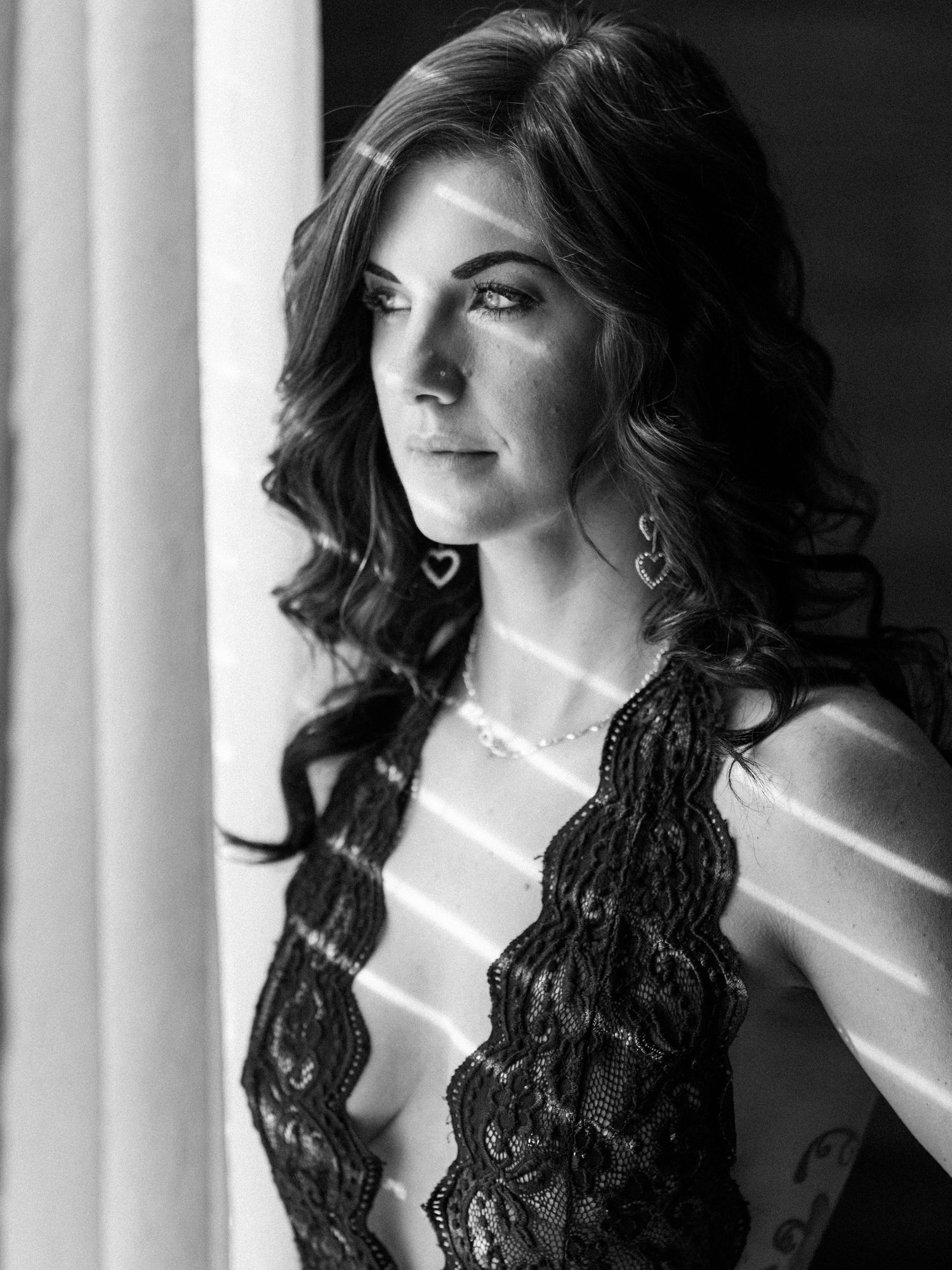 Boudoir portrait of a Knoxville woman by a window taken by dandridge TN boudoir photographer for her birthday photo session