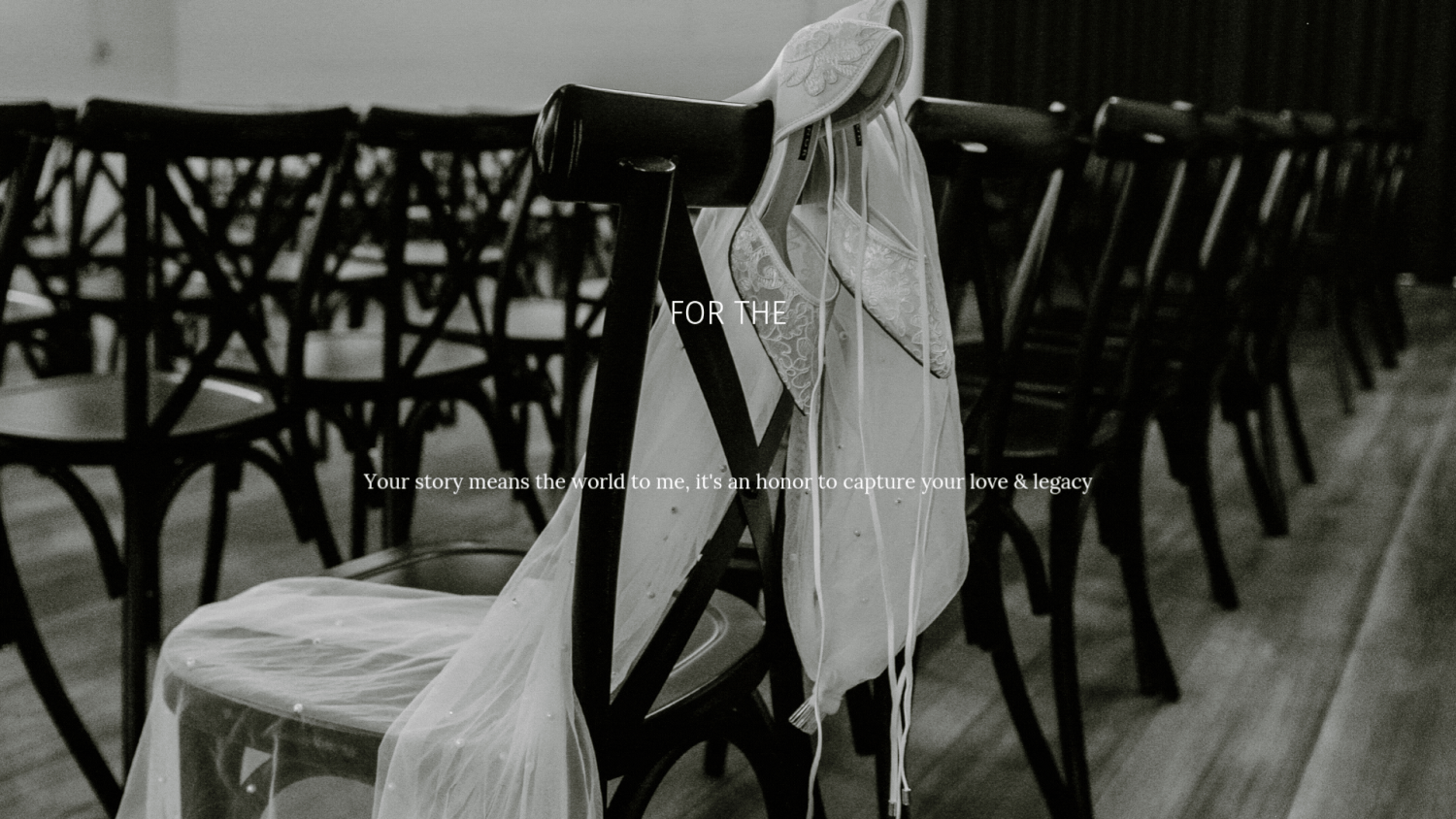 A white veil or fabric hangs delicately over a dark wooden chair in a black and white vintage photograph.