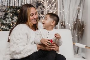 A cozy winter scene of sharing warm moments and laughter against a sparkly holiday backdrop.