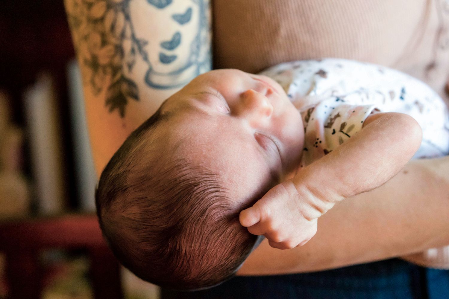 baby girl stretched back in mama's arms