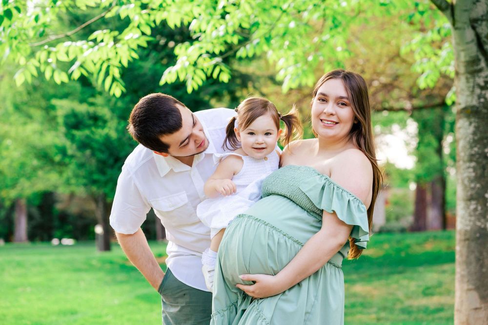 portrait of a young family before baby brother is born