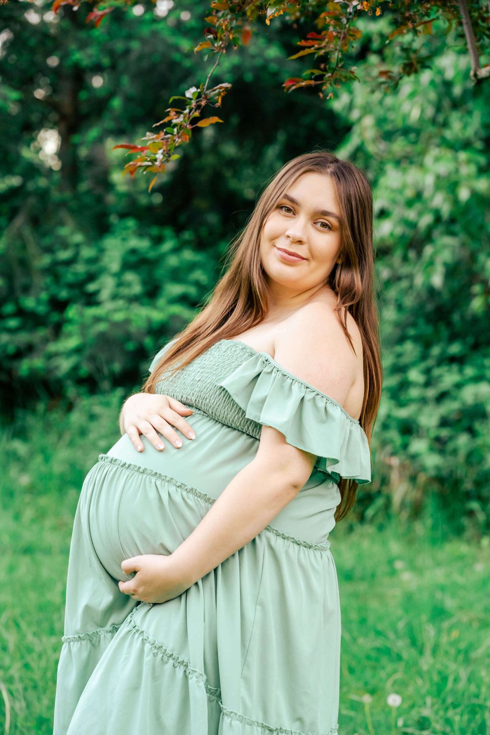 portrait of a pregnant mama with a green dress