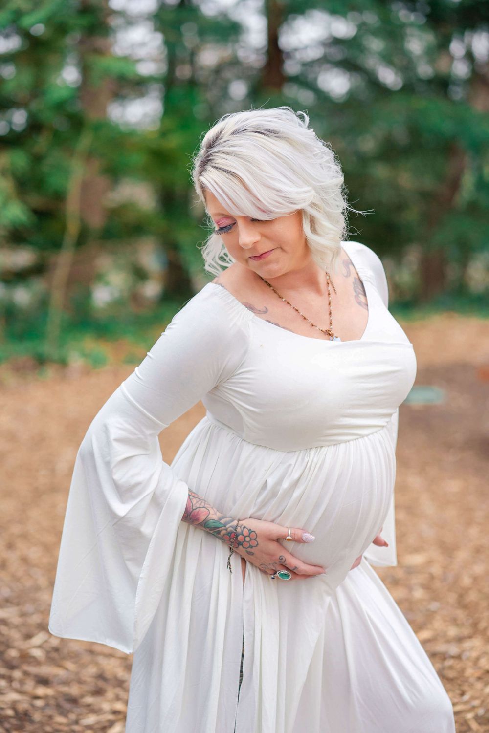 maternity portrait of mom in a white dress