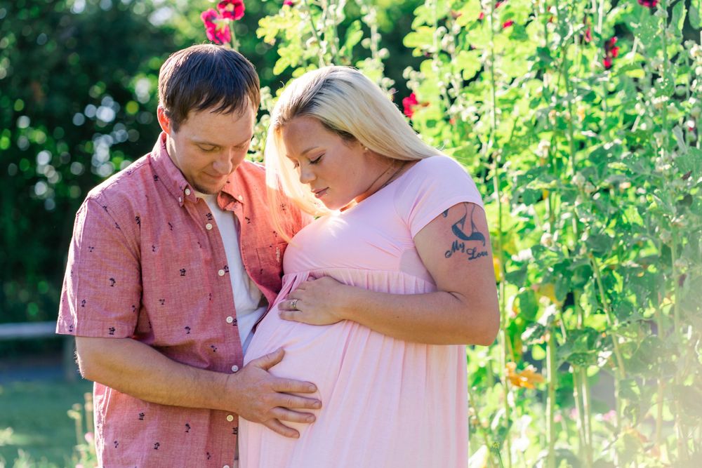 mom and dad look at baby belly