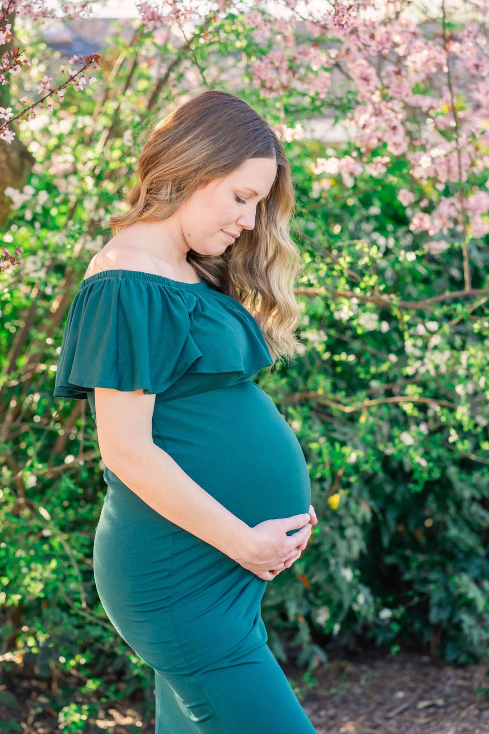 maternity portrait of mom looking at baby bump
