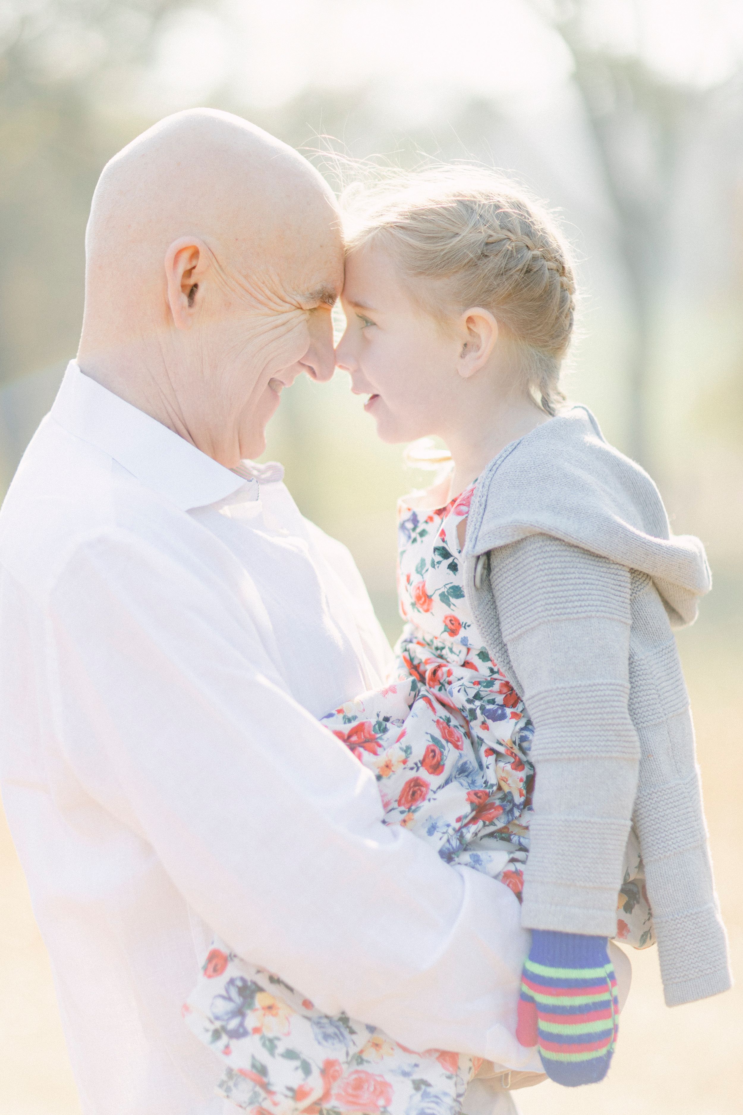 An intimate moment between two people sharing a tender embrace in golden sunlight.