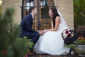 A romantic wedding photo sequence showing the couple posing against a brick wall with an arched doorway.
