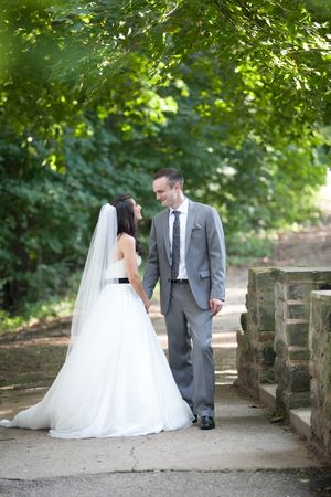 A romantic wedding photo sequence showing a couple sitting on a stone bridge in a lush garden setting.