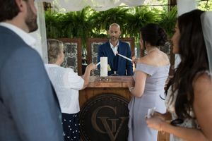 Wedding guests mingle and socialize during an outdoor reception celebration.