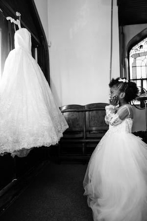 A black and white photo series showing the flowing movement of a bride's white wedding dress and veil in different angles.