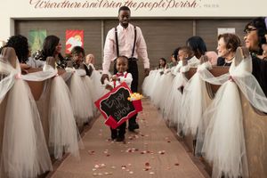 Brides in white dresses gather together during a wedding celebration event.