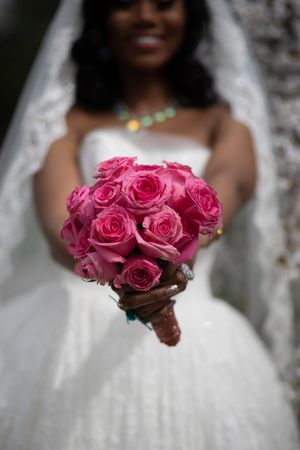 A sequence of wedding photos showing a bouquet of vibrant pink roses held against a white wedding dress.