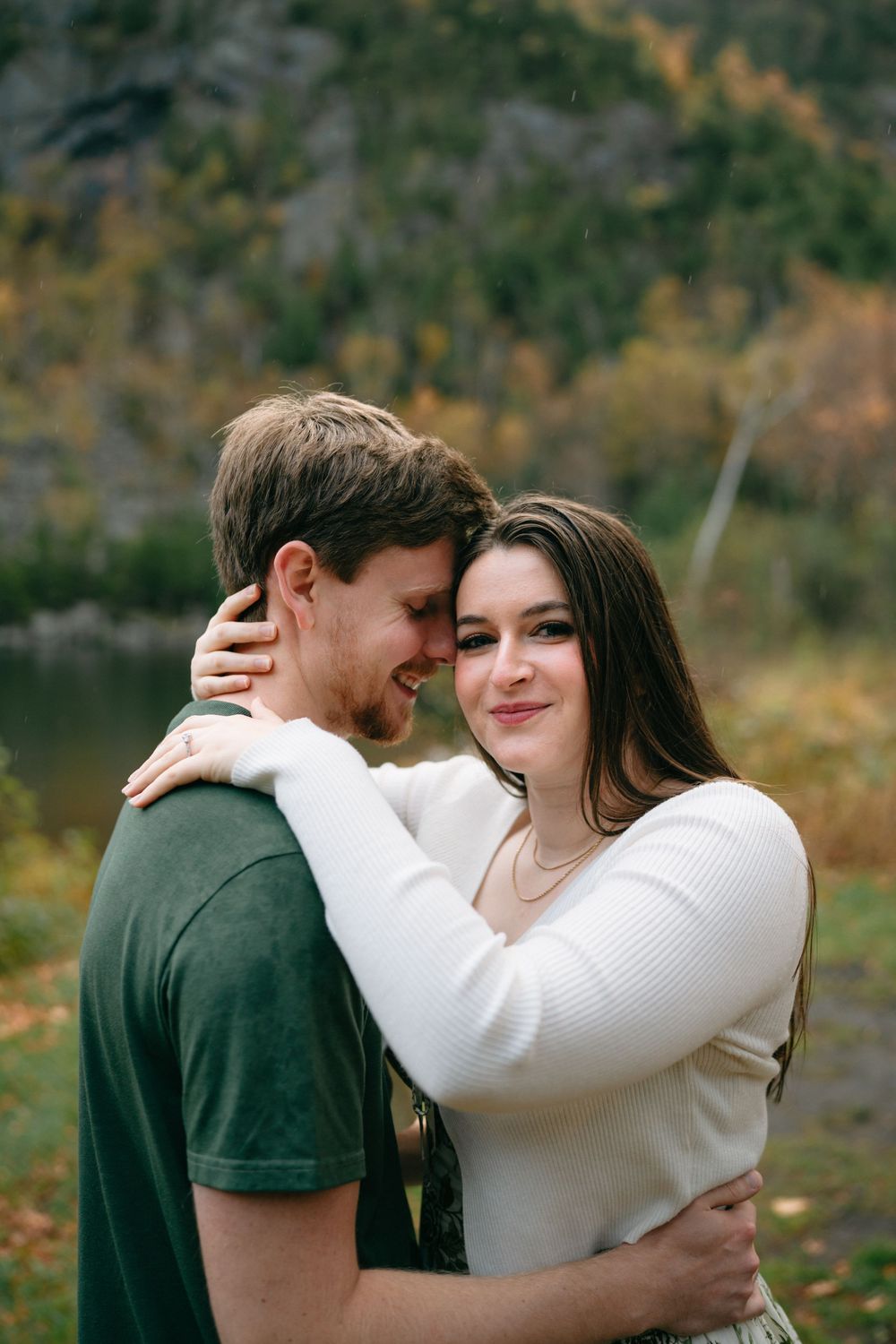Intimate couple shares tender moments against a backdrop of autumn mountains and a serene lake.