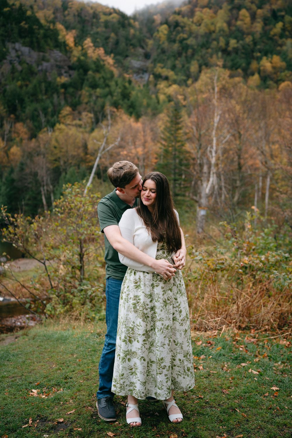 A romantic autumn engagement photoshoot sequence in a mountainside forest with fall foliage in the background.