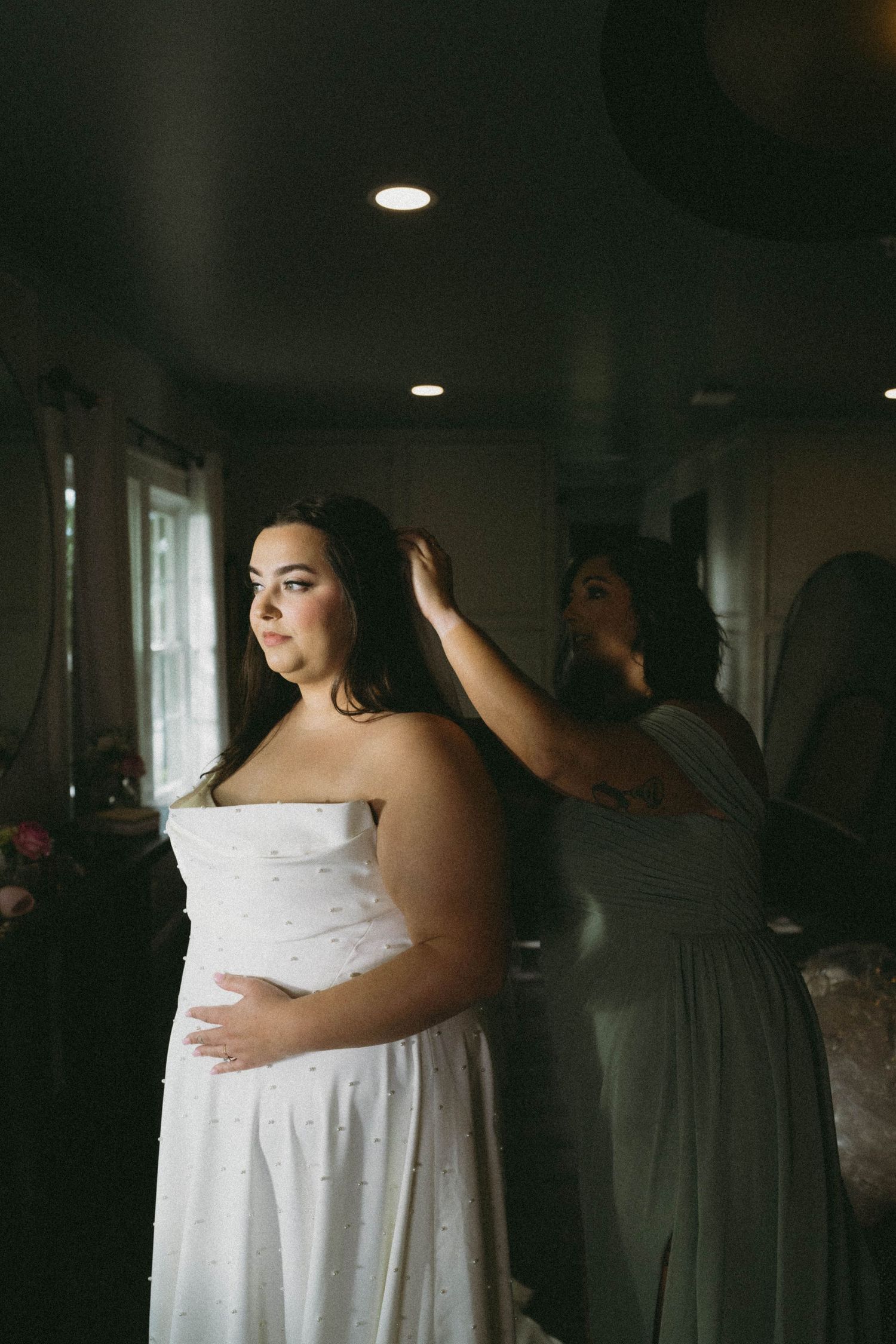 A series of wedding preparation photos showing a bride in a white dress getting ready in a dimly lit room.