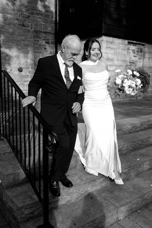 bride and father walking down isle black and white