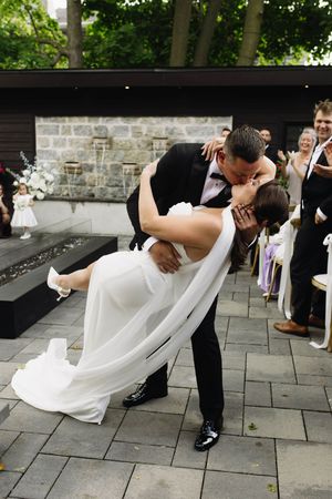bride and groom dip and kiss