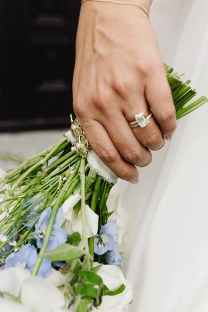 bride with rings and flowers