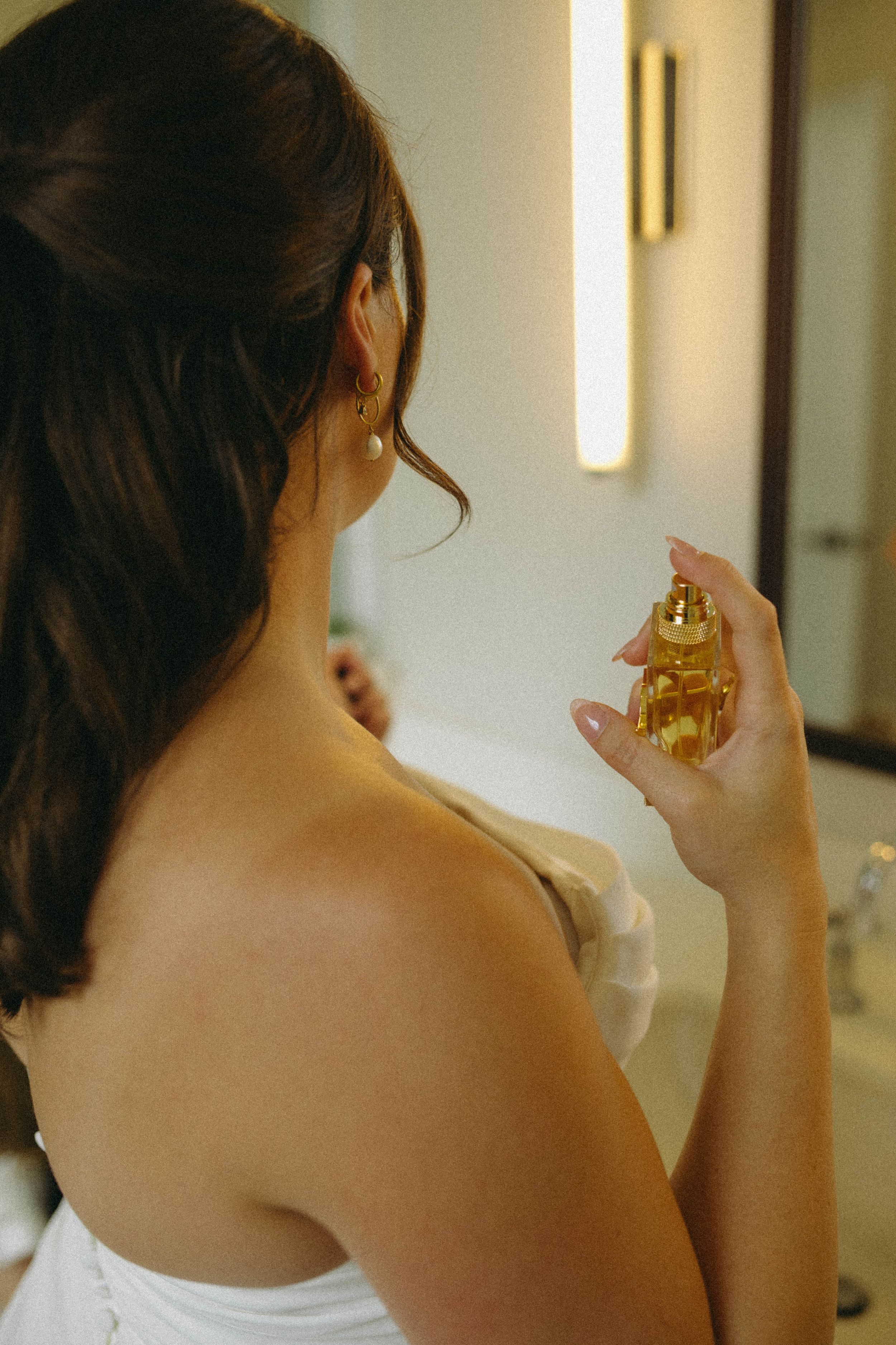 bride spraying perfume
