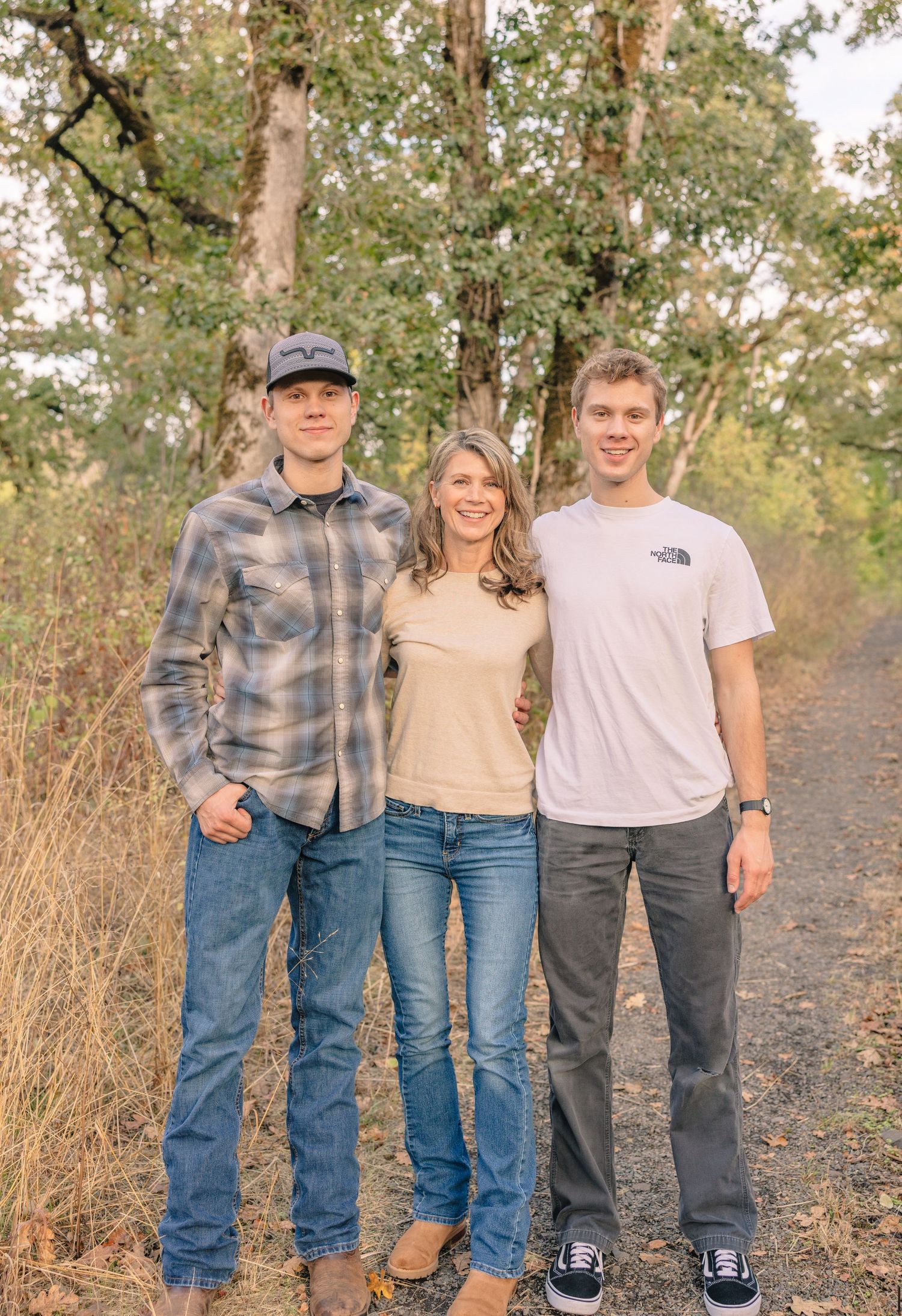 Family group photos taken on a nature trail during golden hour.