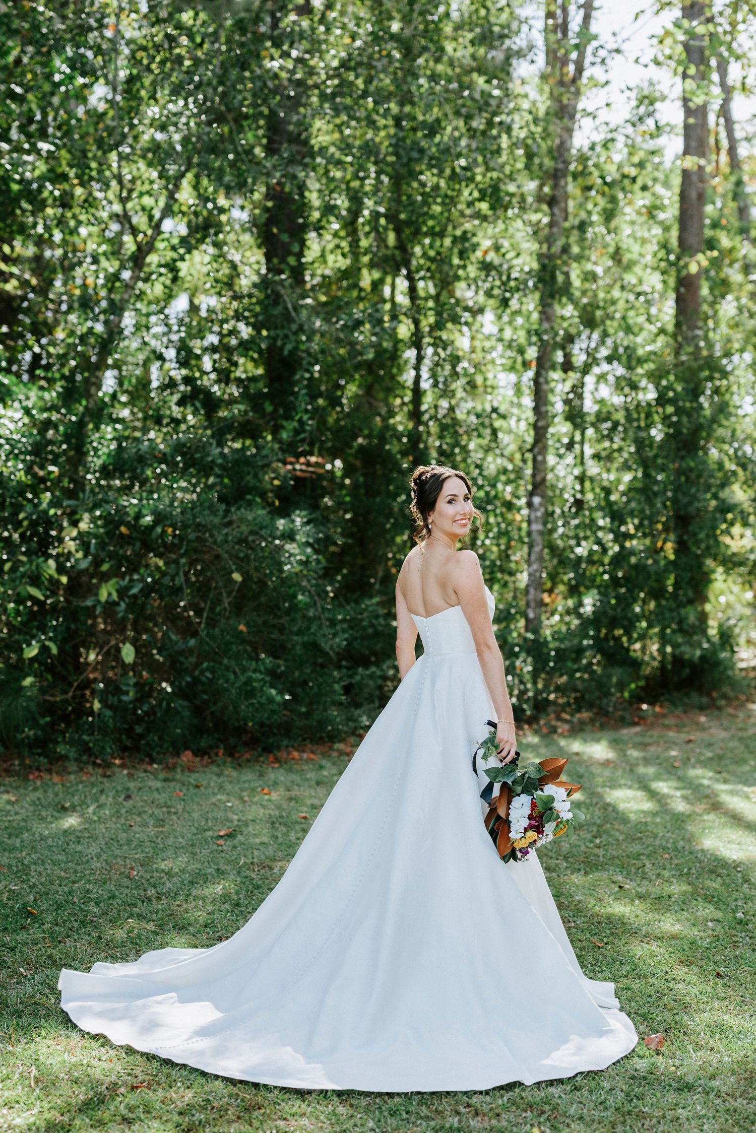 A stunning bridal portrait series showing a flowing white wedding gown against a lush green forest backdrop.