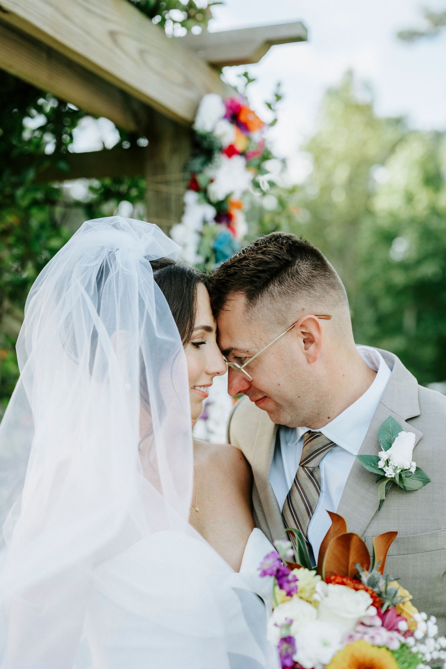 An intimate wedding moment captured with a couple in formal attire sharing tender glances.