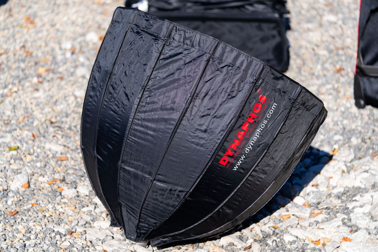 Close-up view of a black waterproof winter glove with red accents showing textured grip details and stitching.