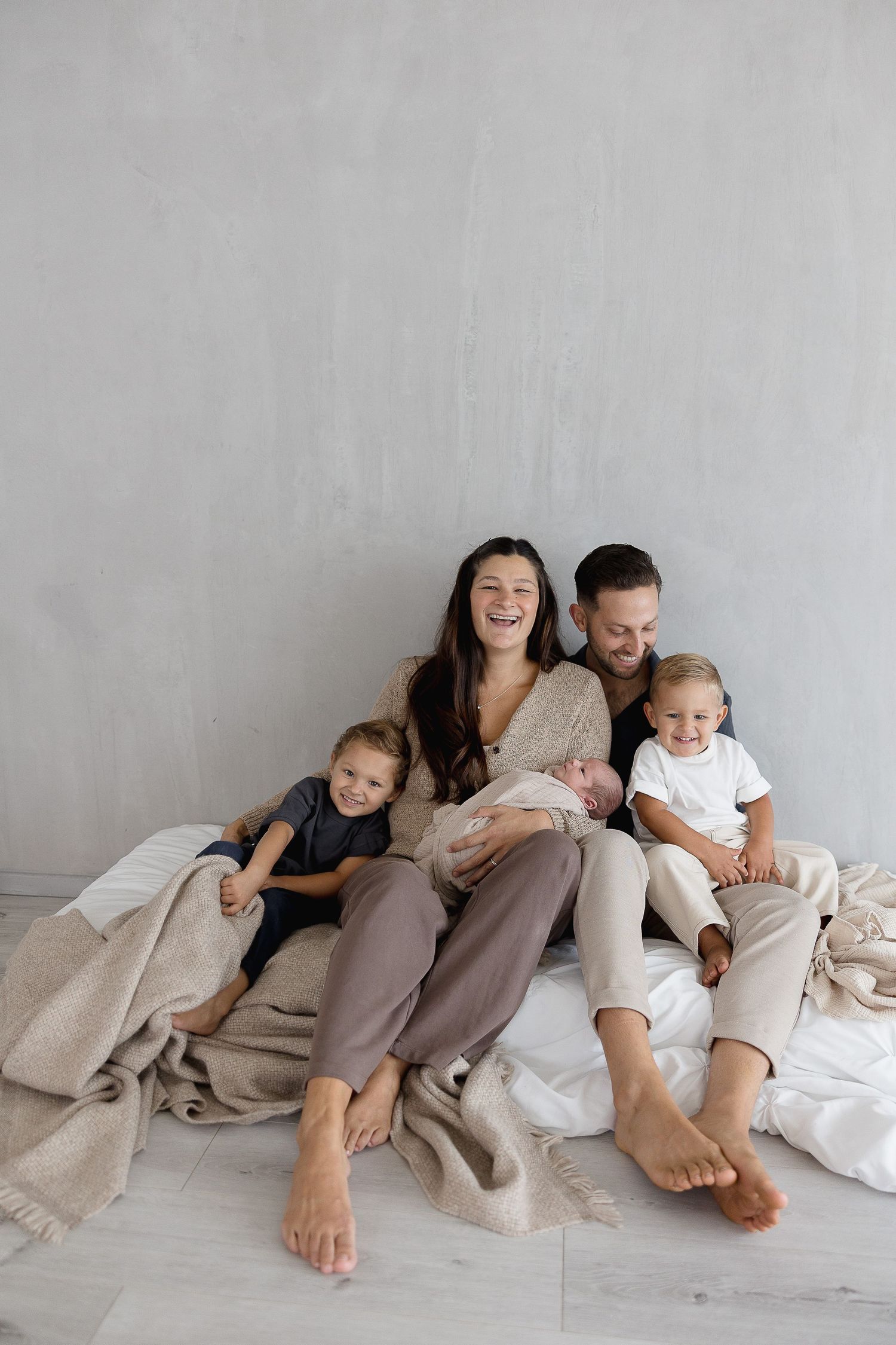 Newborn photography boys session in California studio with parents smiling
