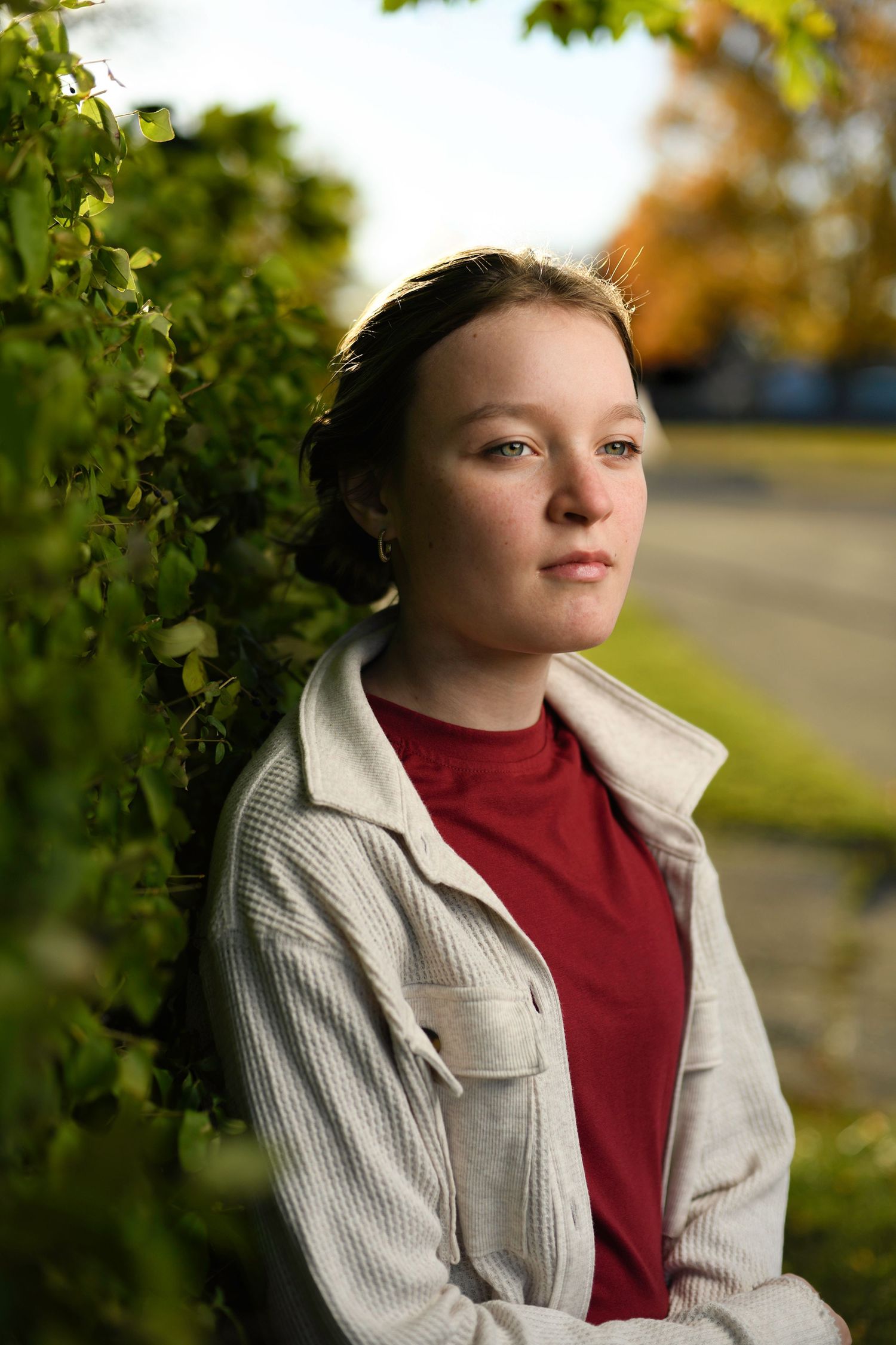 Close-up portrait with crisp flash lighting and soft golden background captured using high-speed sync technique.
