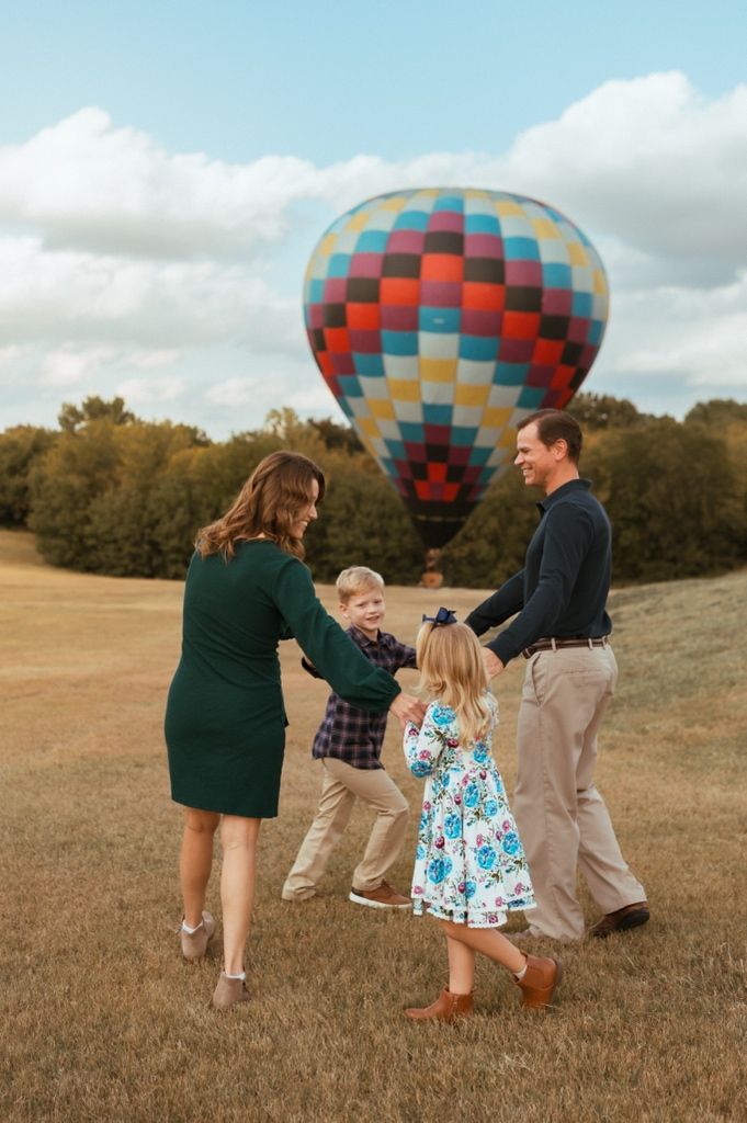 A series of candid photos showing people walking together in a grassy field with colorful hot air balloons in the background.