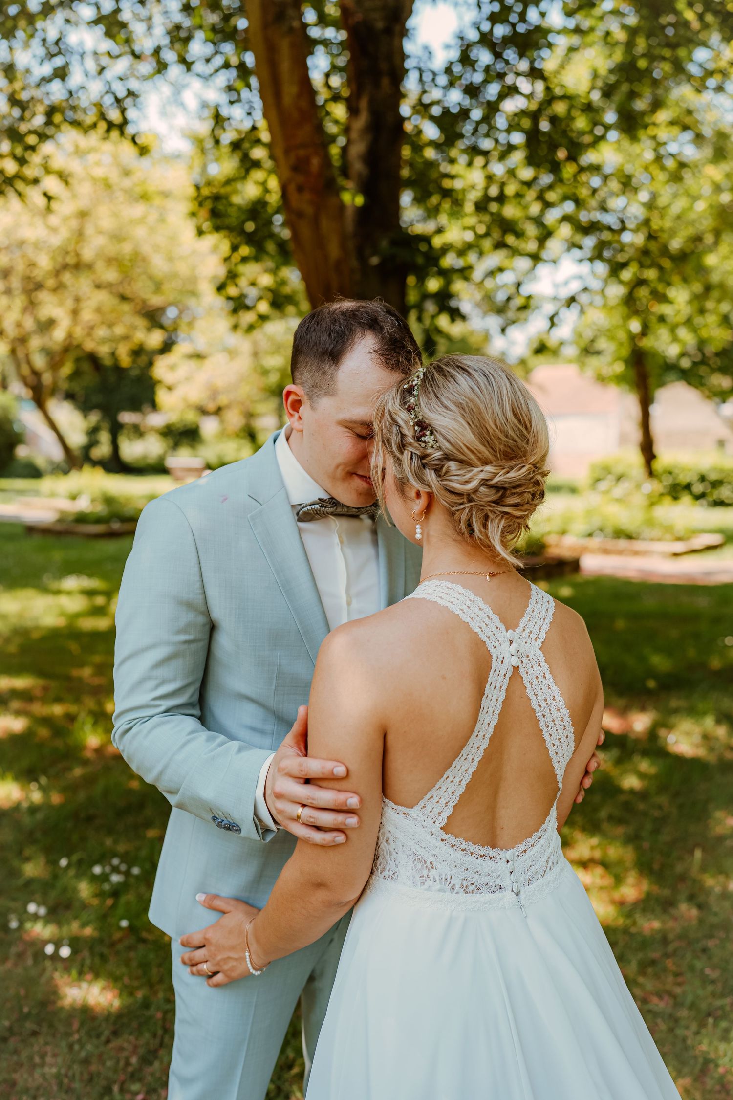 A black and white photo sequence shows a couple sharing a romantic kiss outdoors in a natural setting.