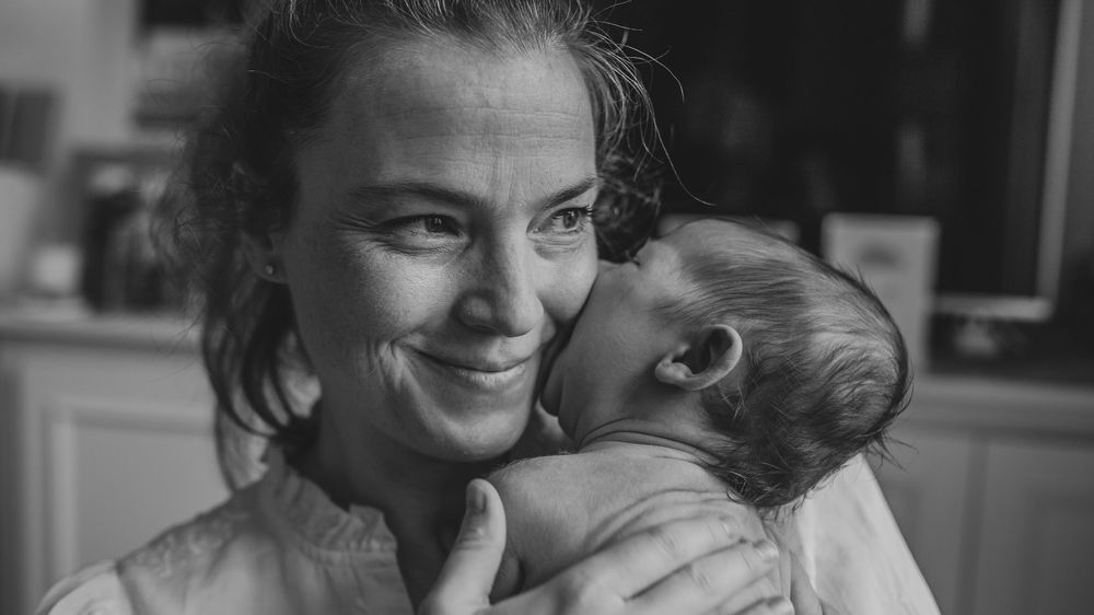 A black and white photo collage shows intimate candid moments between a couple sharing affectionate gestures.