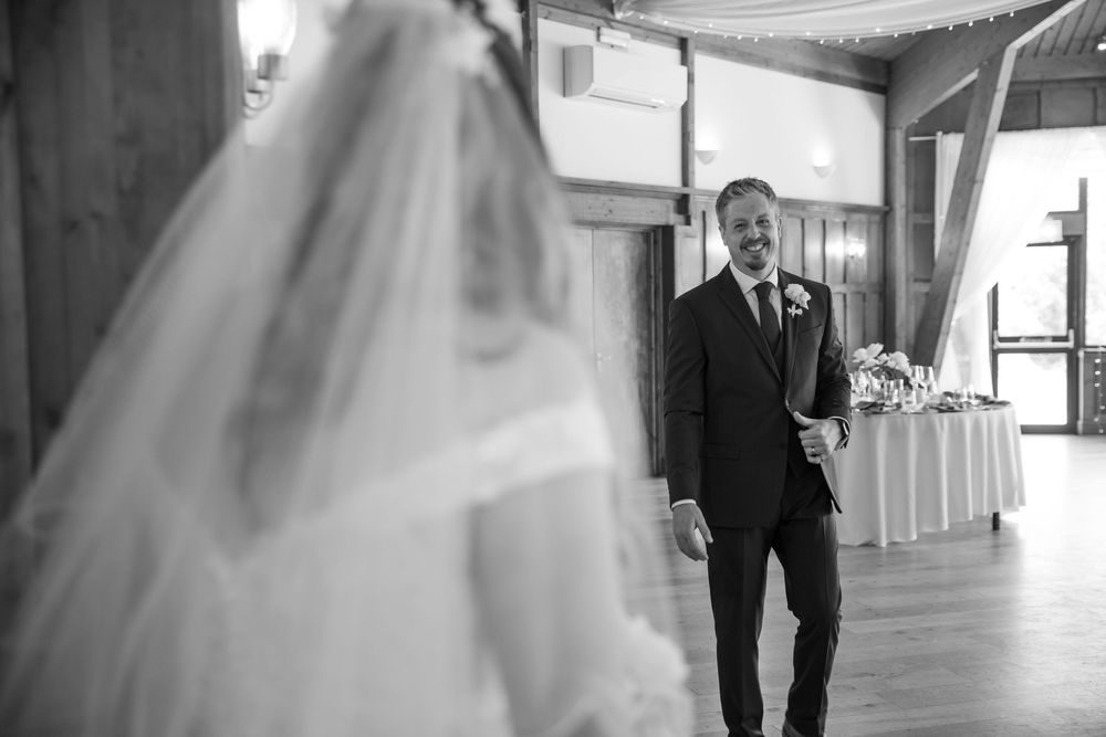 A black and white wedding photo sequence showing a couple dancing together in an elegant venue.