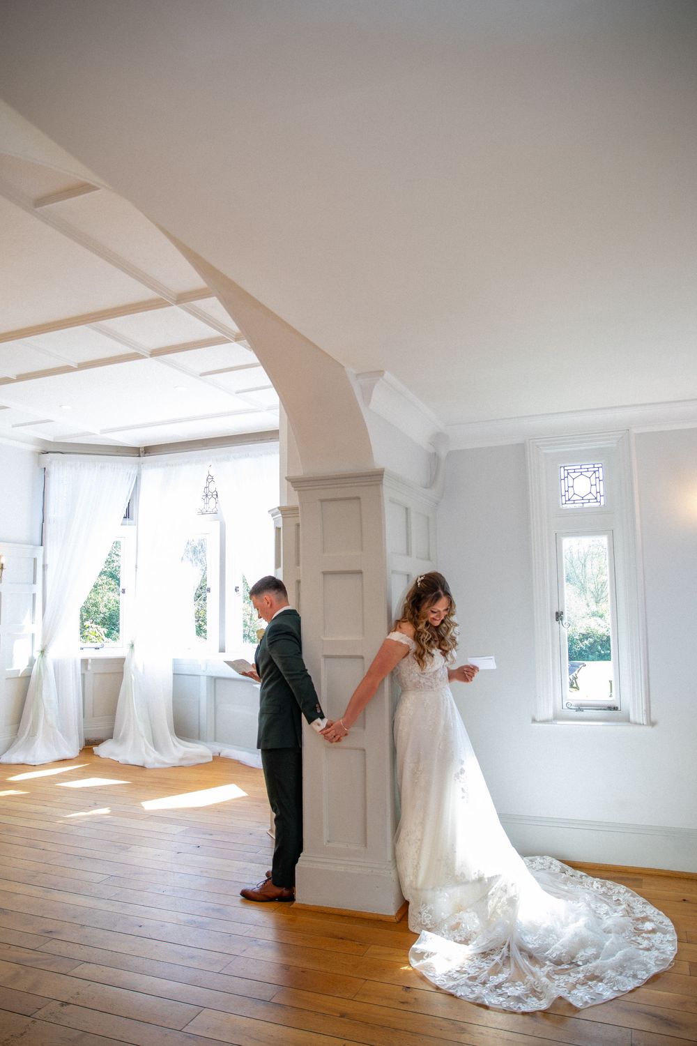 Bright white room with hardwood floors and windows showing artistic wedding photography sequence.