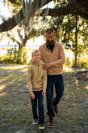A series of walking shots on a path beneath Spanish moss draped trees at sunset.
