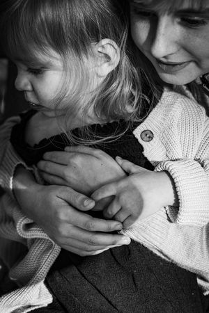 Black and white sequence of tender moments between parent and child.