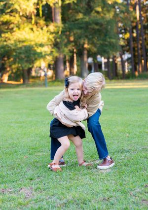 Playful sequence of children running and playing together on grass in golden sunlight.