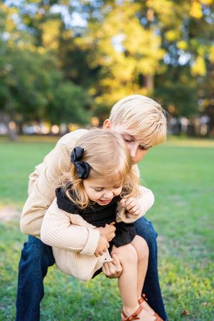 Playful family moment captured in a series of photos outdoors.