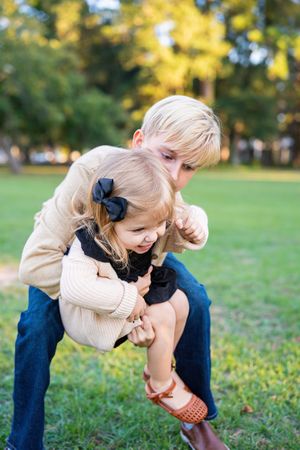 Playful outdoor family moments captured in golden evening light.