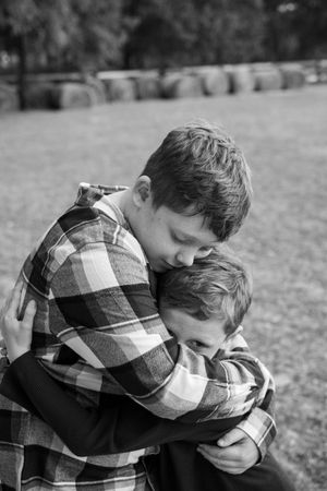 Black and white sequence of a plaid-shirted figure leaning forward in a grassy outdoor setting.