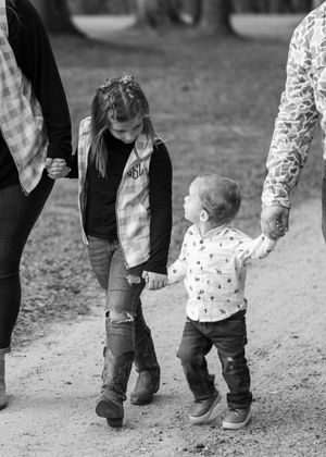 Close-up of walking feet and legs showing coordinated casual family outfits.