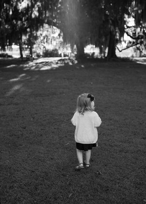 A sequence of photos showing someone walking across a grassy lawn in the shade.