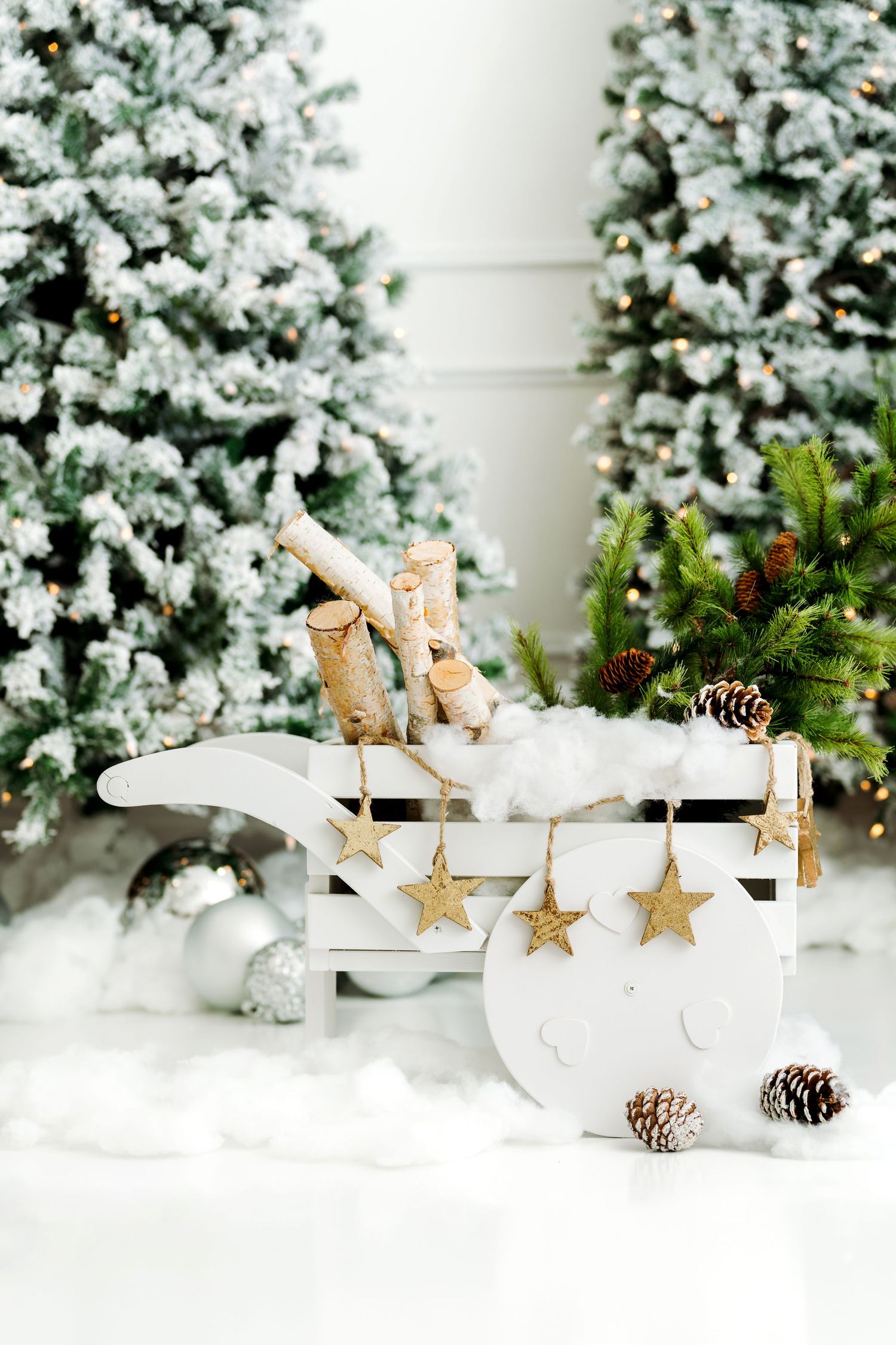 festive wagon filled with hand cut Christmas trees for toddler and baby