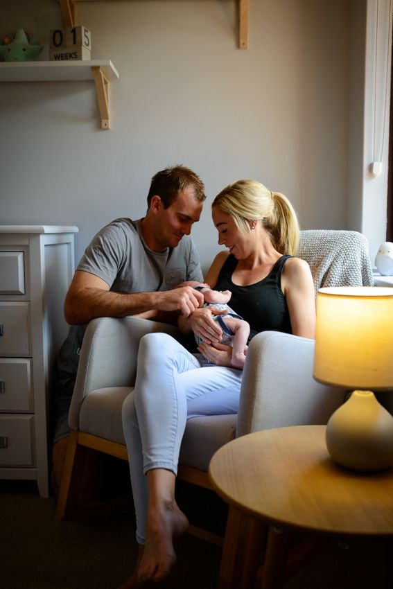 A new mum and dad with their newborn in a nursery - Kelly Chapman Photographer Perth