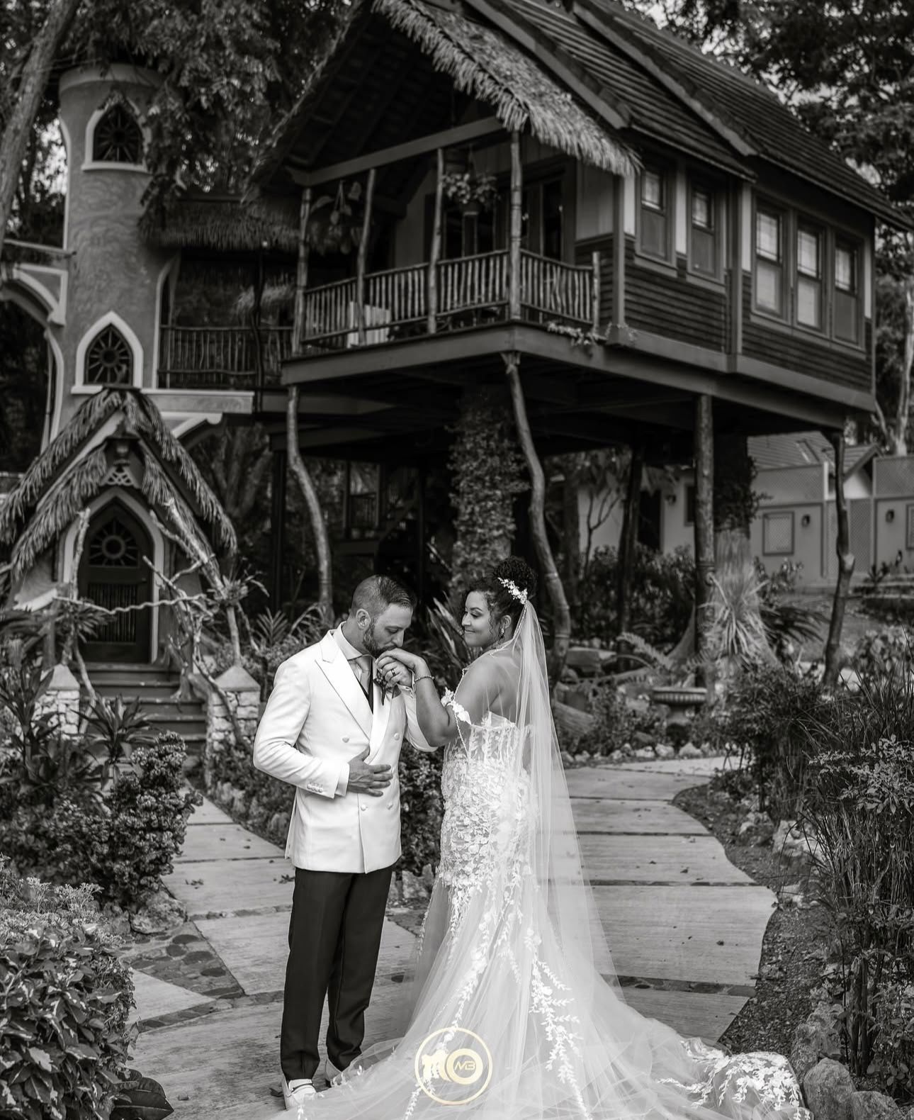 Black and white wedding photos captured on rustic wooden porch with classic architecture.