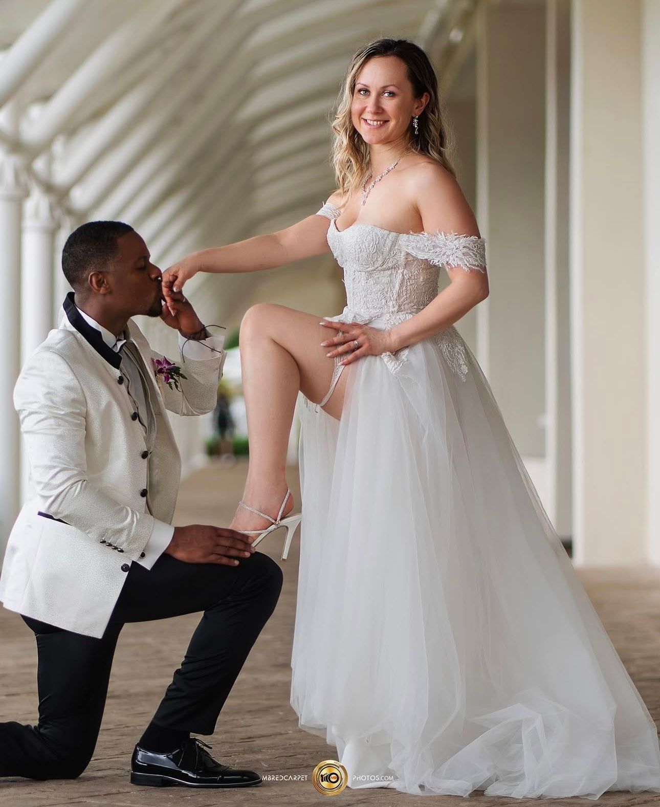Candid moments between couple during wedding ceremony preparations in elegant indoor venue.