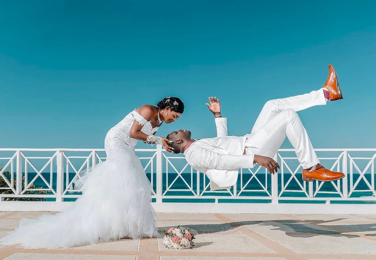 Creative sequence of couple posing on white boardwalk against bright blue sky.