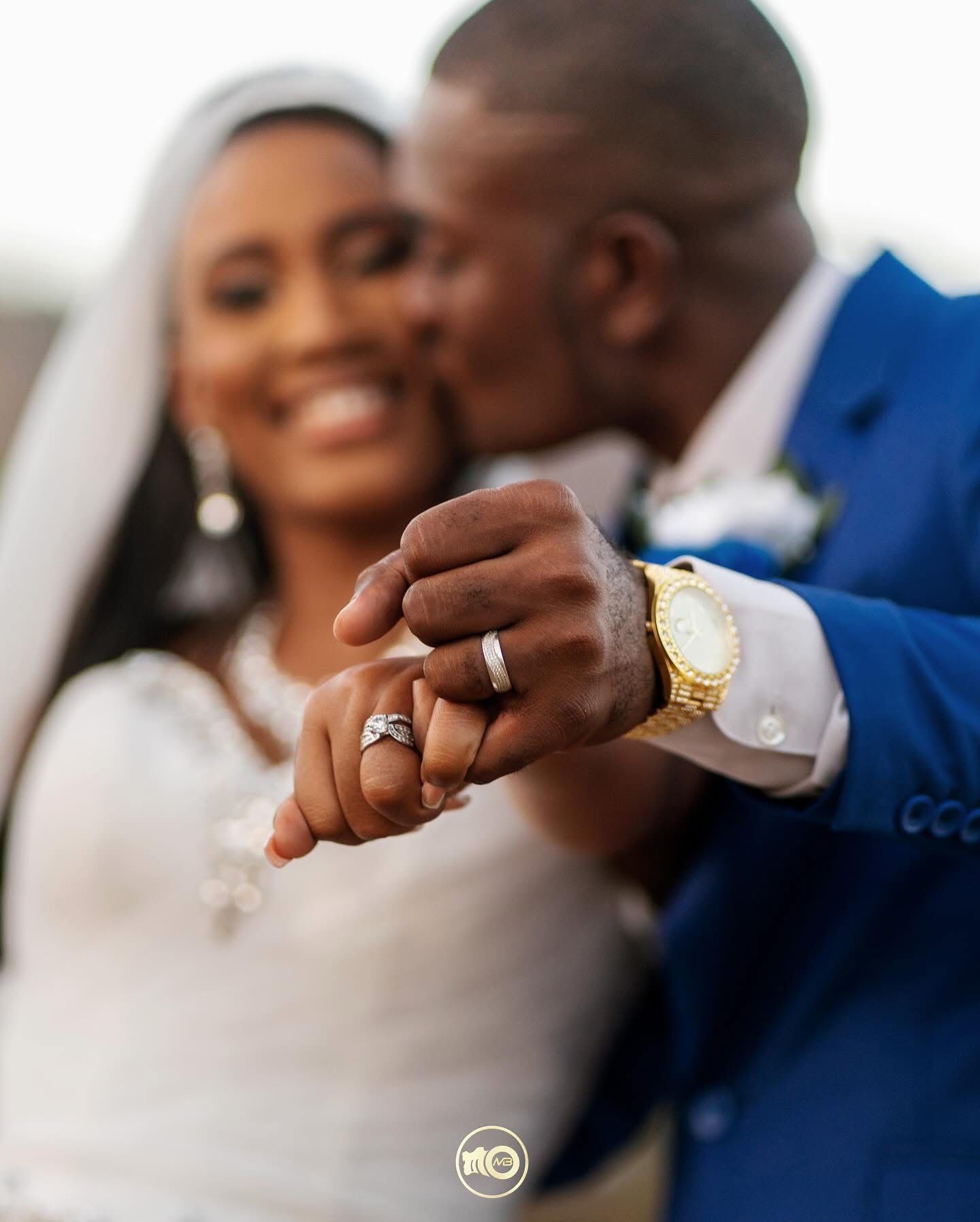 Close-up view of hands showing wedding rings during a celebration.
