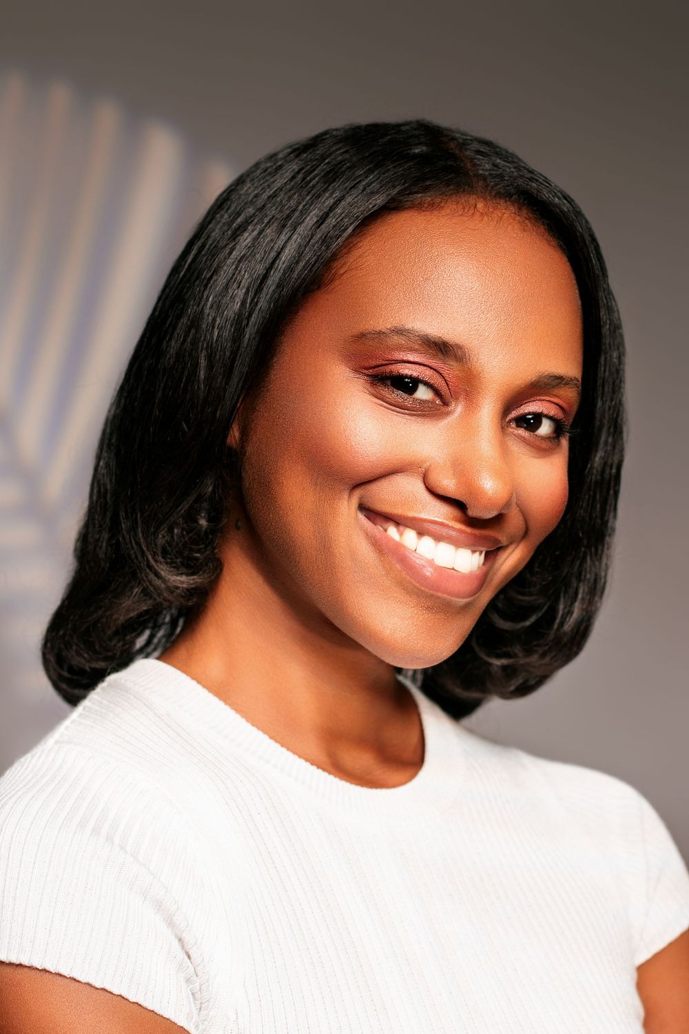 Portrait series showing joyful expressions in white ribbed top against neutral backdrop.