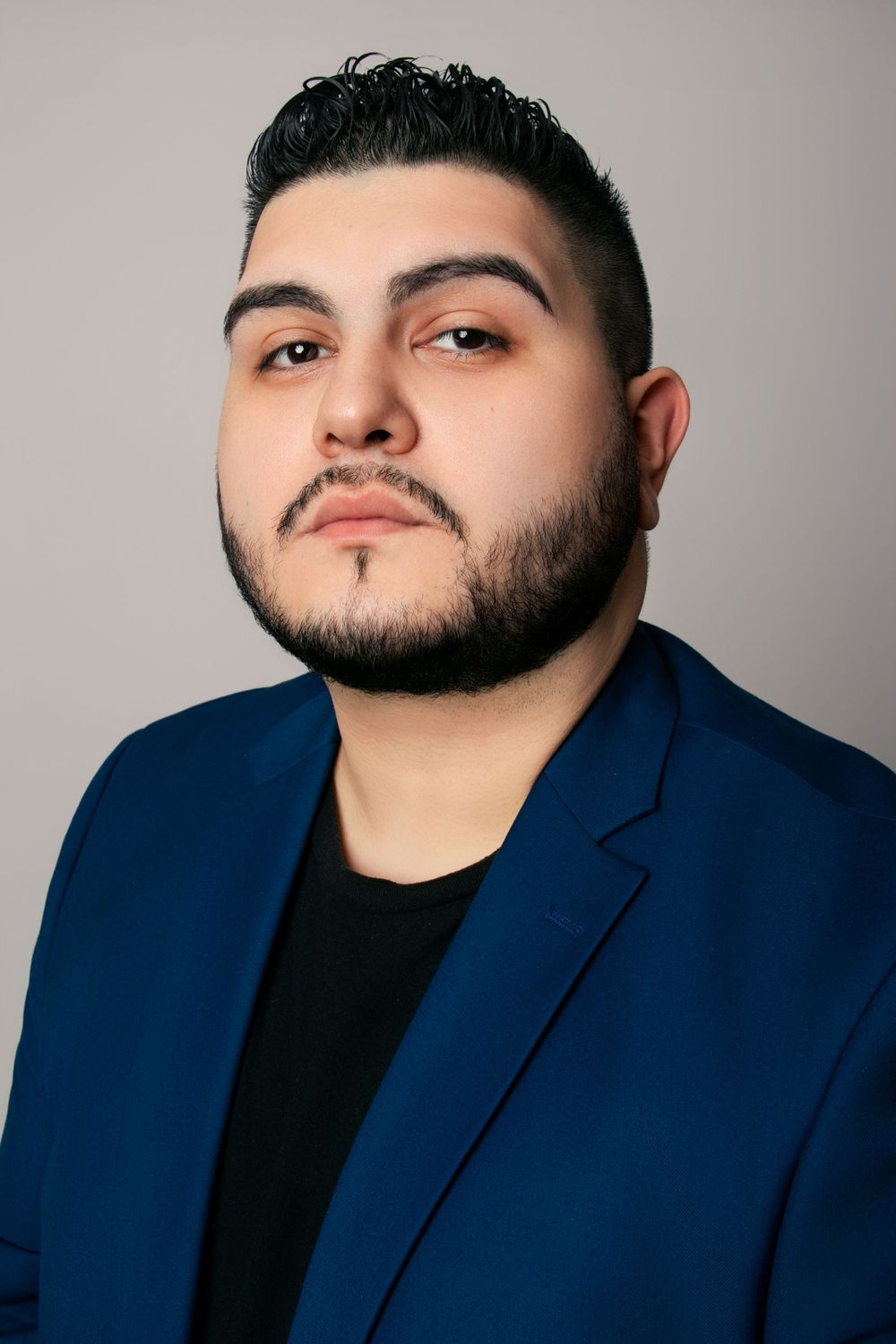 Headshot series showing different angles and expressions against neutral studio backdrop.